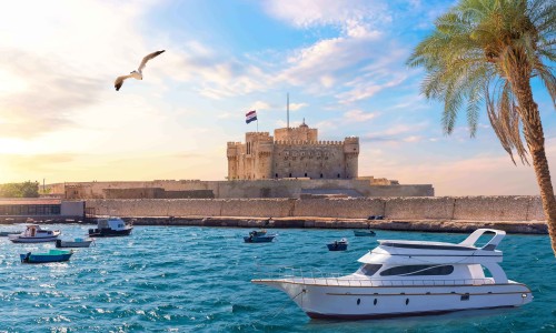 Boat in the Mediterranean in front of Citadel of Qaitbay, Alexandria, Egypt.