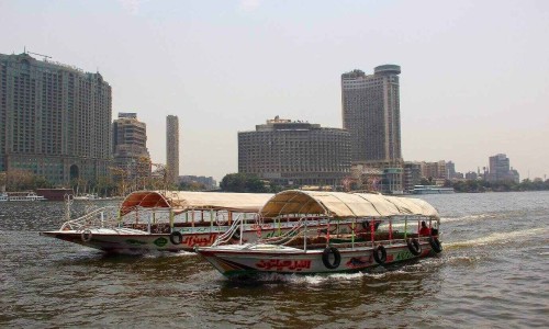 Tourists inside a roofed pleasure boat on a sightseeing trip, sailing down the Nile river,Cairo.Egypt.